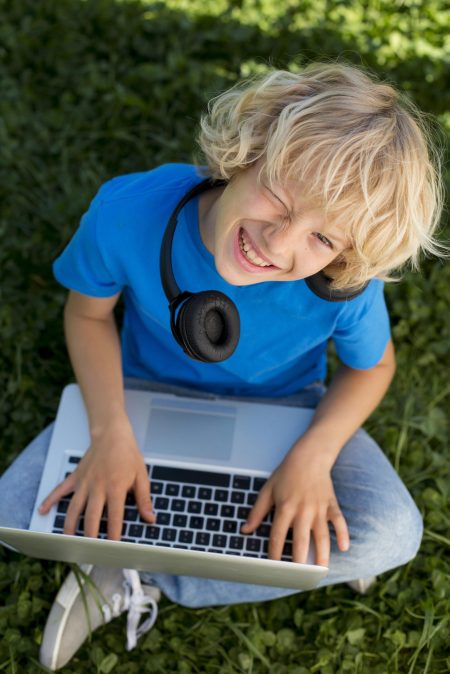 little boy with laptop and headphone